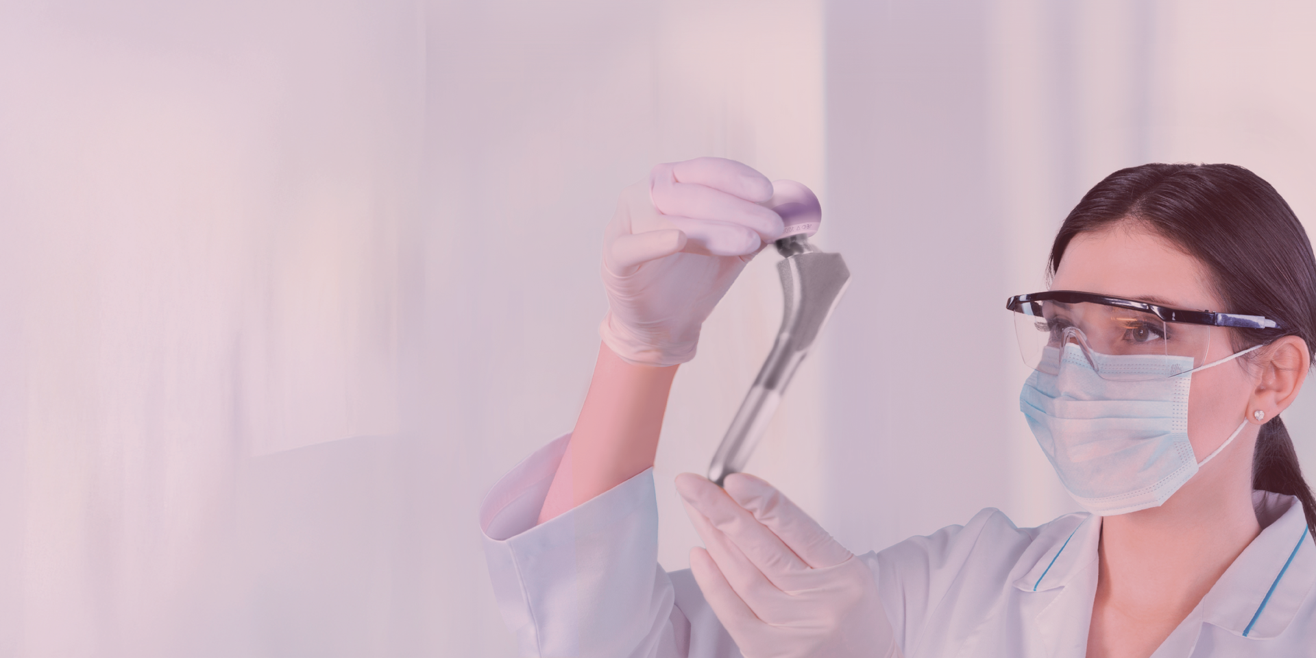 Clinician wearing protective equipment and holding a stem with an ceramic femoral head out of BIOLOX delta, accompanied by the text promoting the benefits of ceramic materials in advanced orthopedic research and patient care, with the BIOLOX® Material Matters logo visible.