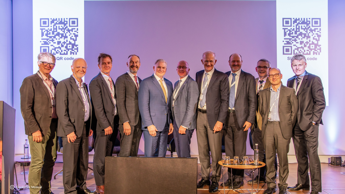 Here you can see a group of speakers standing together on stage at the 'Great Debate' event in 2025. The speakers have different areas of expertise and talk about current issues and news in THA and TKA.